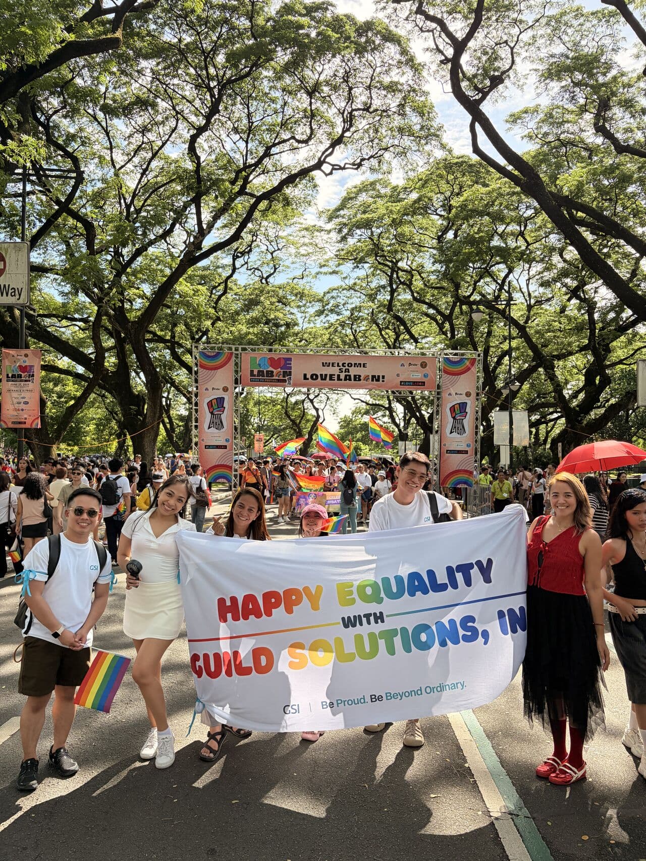 GSI team members marching with a Happy Equality banner