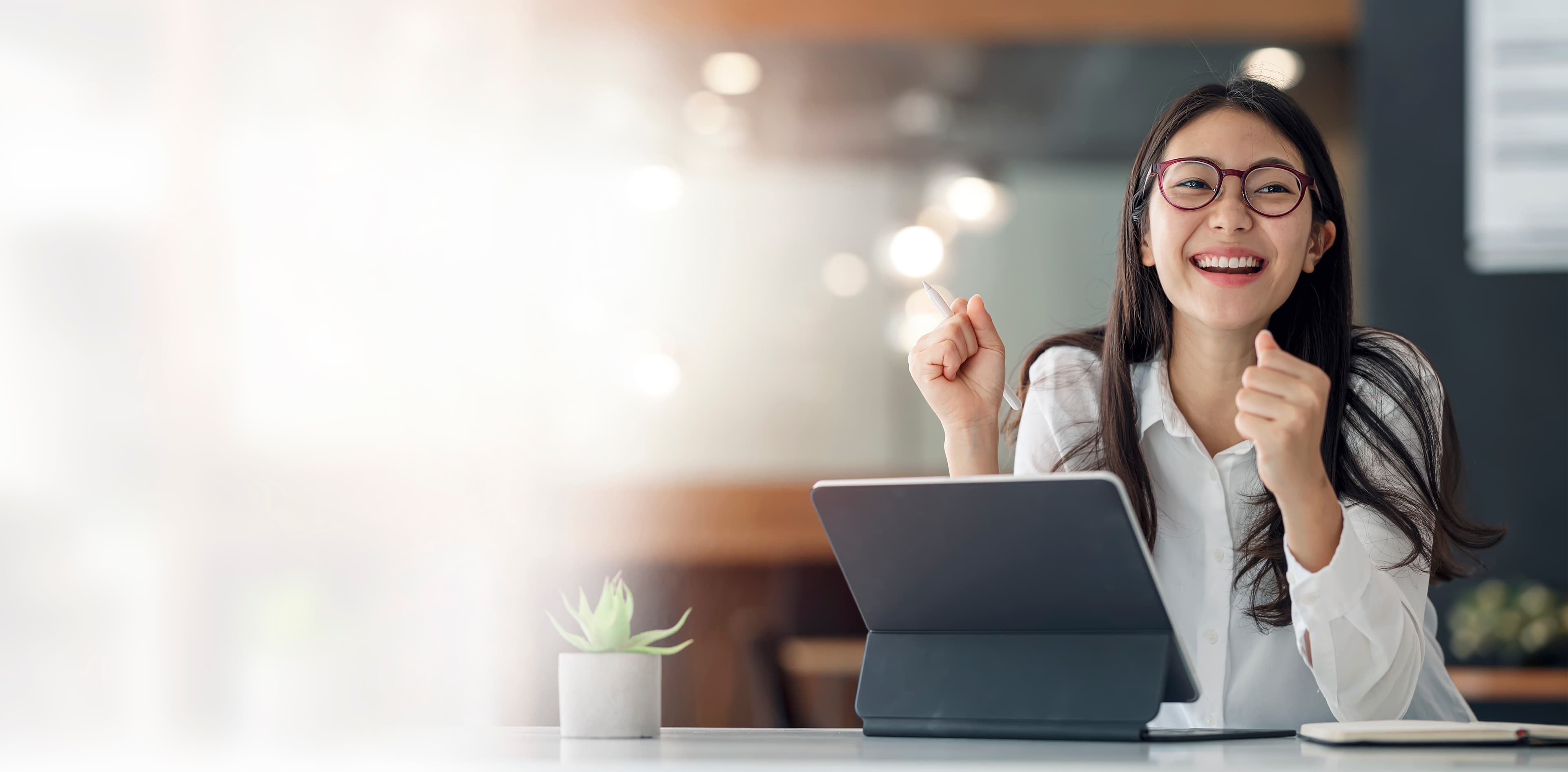 A team member smiling while working at a laptop